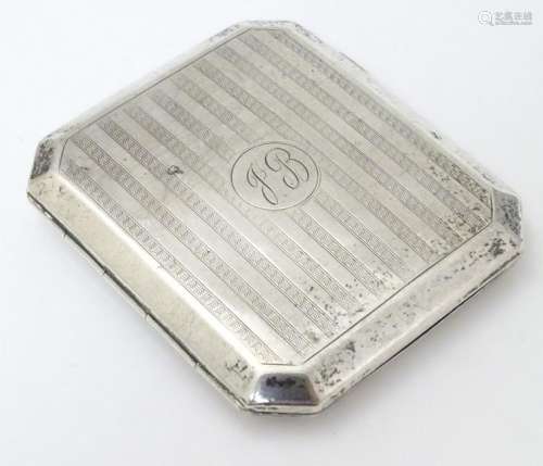 An Art Deco silver cigarette case with engine turned