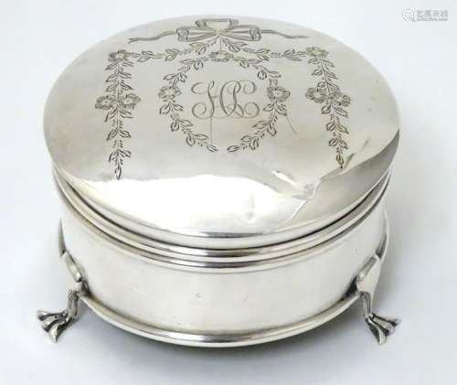 A silver ring box  of circular form on 3 feet with