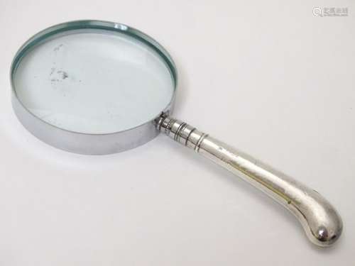 A silver handled magnifying glass. 6 Â¾'' long overall.
