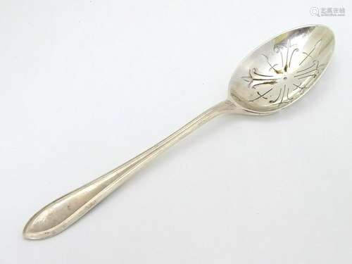 A silver straining spoon with pierced bowl hallmarked