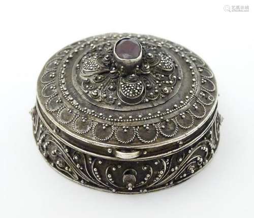 A 925 silver pill box of circular form with red stone