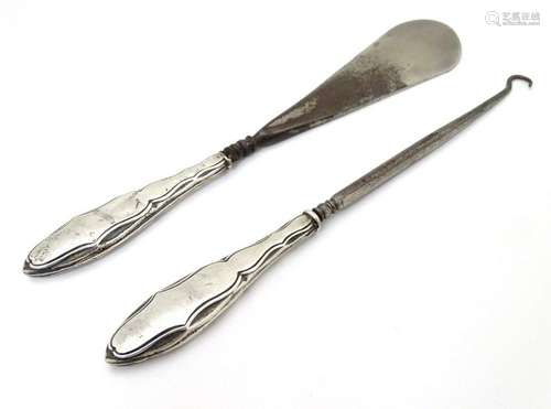 A silver handled button hook and shoe horn. Hallmarked