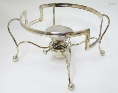 A large silver plated four footed stand with spirit