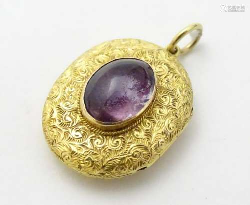 A 19thC gold locket of oval form with engraved