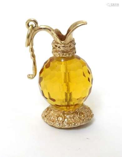 A novelty pendant charm formed as a jug set with facet