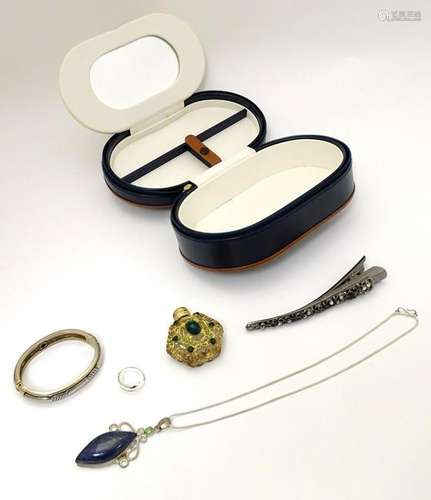 A leather jewellery case of ovoid form containing a 925