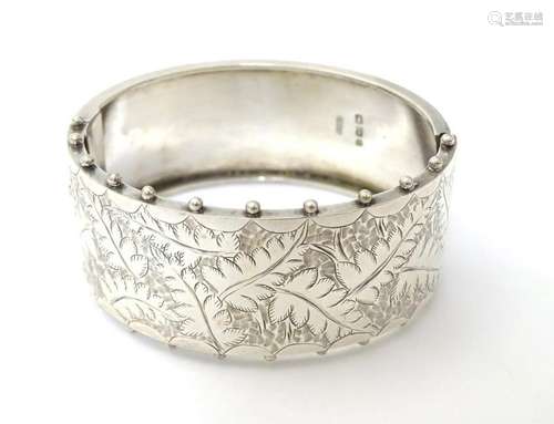 A Victorian silver bangle of bracelet form with