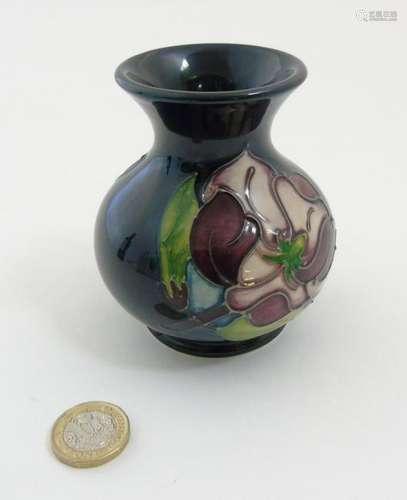 A 1994 Moorcroft Magnolia vase on dark blue ground,