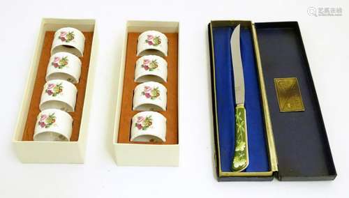 Two sets of four cased Coalport ceramic napkin rings,