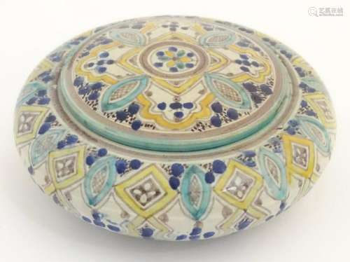 An Islamic circular lidded pot decorated with banded