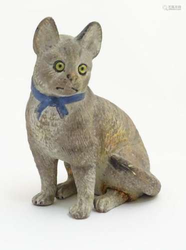 A ceramic model of a seated cat with large ears and a