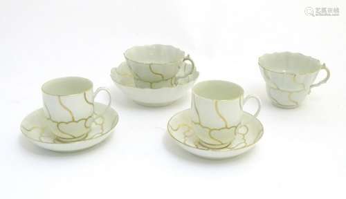 A pair of 18thC porcelain tea cups and saucers in the