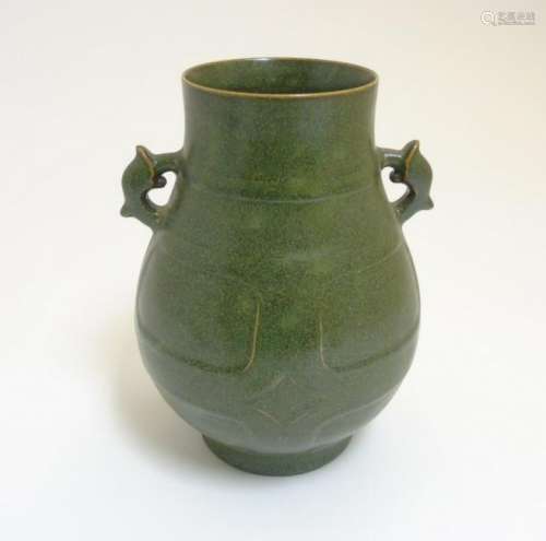 A Chinese tea dust glazed Hu vase, having handles in