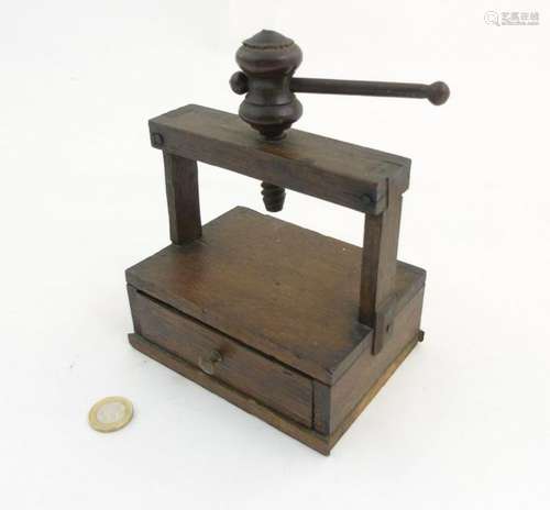 A late 19thC / early 20thC oak miniature book press /