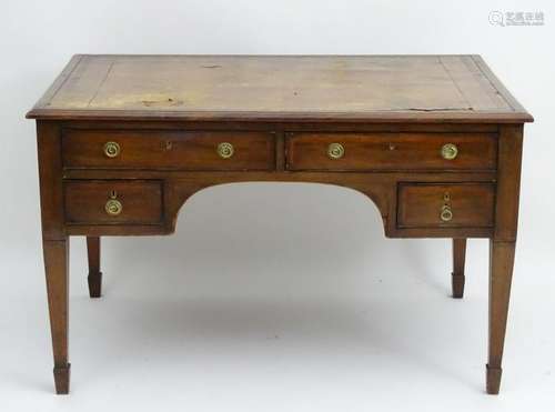 An early 20thC four drawer mahogany desk with an inset