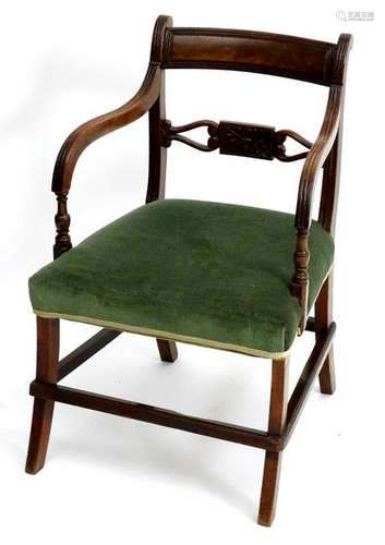 A Regency mahogany open armchair with a reeded curved