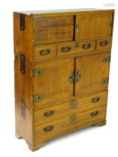 A c.1900 three sectional elm tansu cabinet, each tier