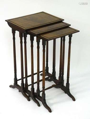 A nest of three early 20thC mahogany tables with