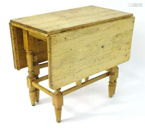 A Victorian pine gate leg table with single short