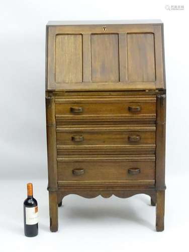 An early 20thC walnut bureau with a panelled fall