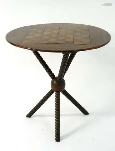 A late 19thC oak games table, having a circular top