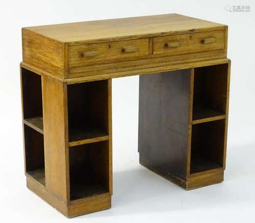 An early / mid 20thC oak Heals style desk, with a