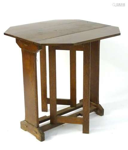 A Cotswold school style oak drop flap table with a