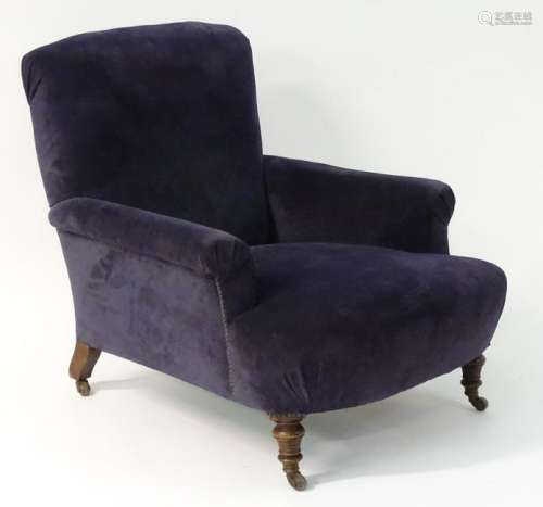 A late 19thC Howard style armchair with a deep seat and