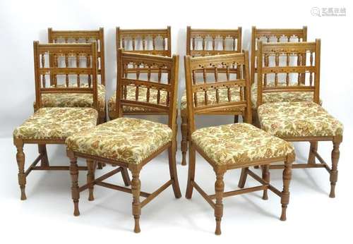 A set of 8 Bruce James Talbert designed oak dining