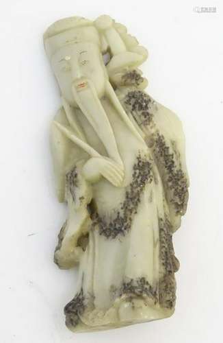 A Chinese carved jade figure of an oriental deity 6''