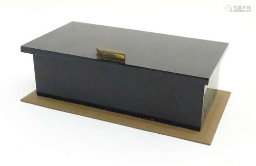 Late Art Deco: a mid century black plastic and brass