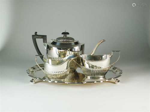 A three piece silver tea service and a silver tray