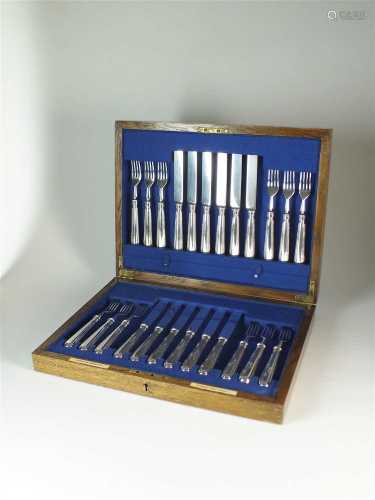 A cased set of twelve silver knives and forks