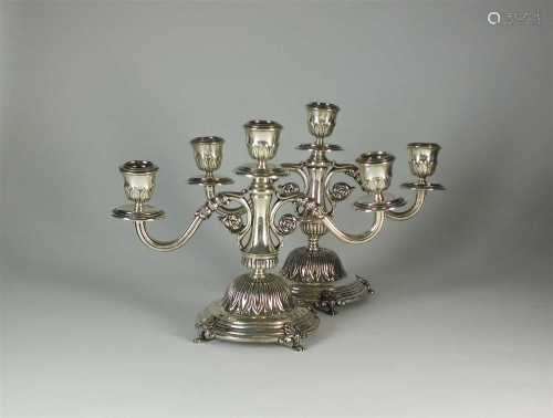 A pair of Egyptian silver candelabra