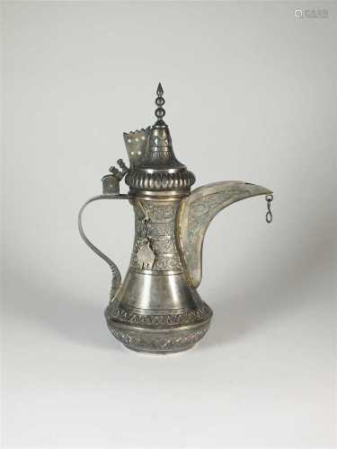 An Islamic white metal coffee pot
