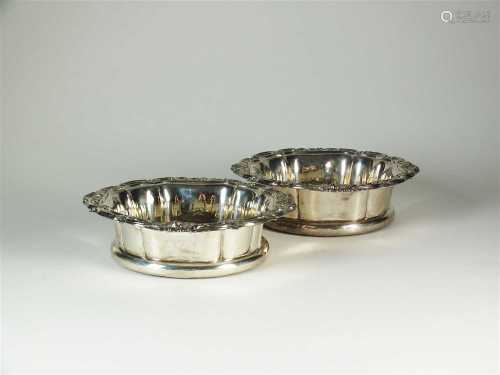 A pair of George IV silver mounted wine coasters