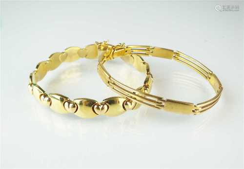 Two yellow metal bracelets