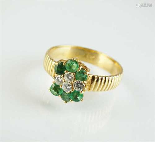 A diamond and emerald cluster ring