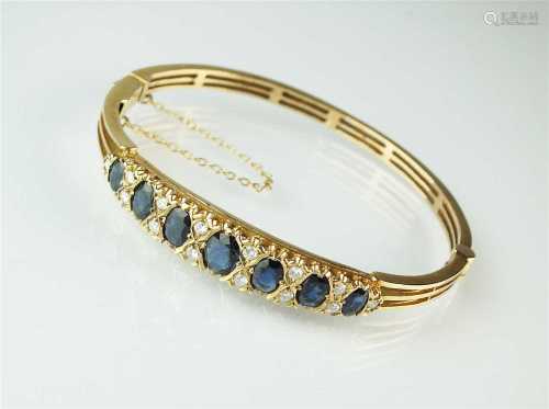 A 9ct gold sapphire and diamond bangle