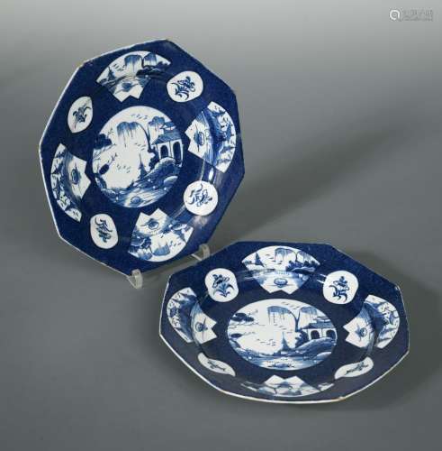 A pair of Bow blue octagonal plates, circa 1770, the central oval panels painted with river