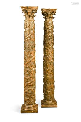 A pair of 18th century Italian carved giltwood column alter candlestick bases, each carved in relief