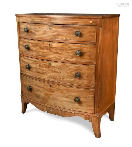 A Regency mahogany bow front chest, of four graduated long drawers, inlaid with boxwood motifs, on