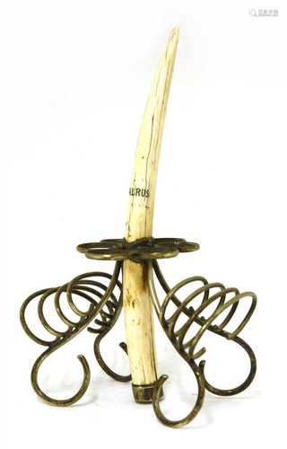 A walrus tusk and silver-plated mounted egg and toast rack,