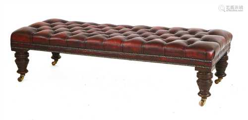 A large button upholstered leather footstool,