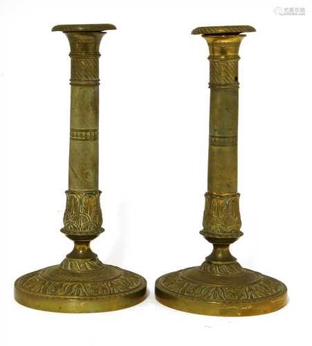 A pair of French gilt brass Directoire candlesticks,