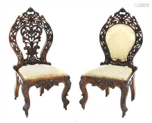 Two similar Anglo Indian carved hardwood chairs,