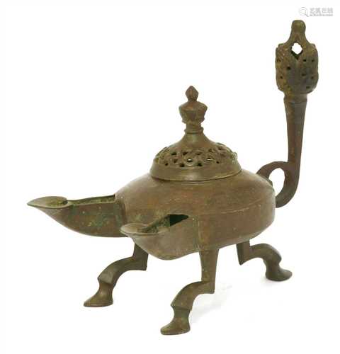 A Persian bronze double-spouted oil lamp,