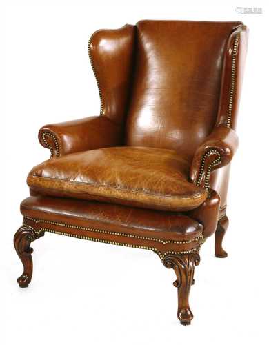 A leather wing back armchair,