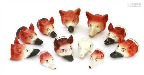 Eleven various pottery fox mask stirrup cups,