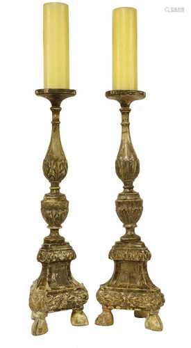 A pair of Italian carved wooden pricket candlesticks,